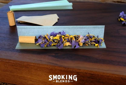 A Pre-Rolled Mystic Hookah Herbal Smoke, Rolling Papers and Tips, Sitting On a Wooden Rolling Tray