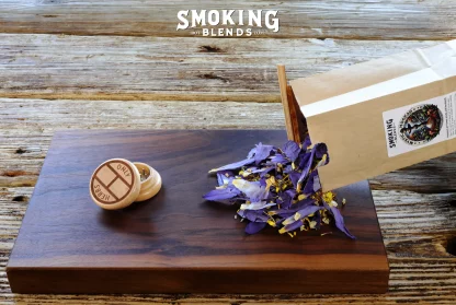 Package of Mystic Hookah being Poured Onto a Rolling Tray with an Herb Grinder On It
