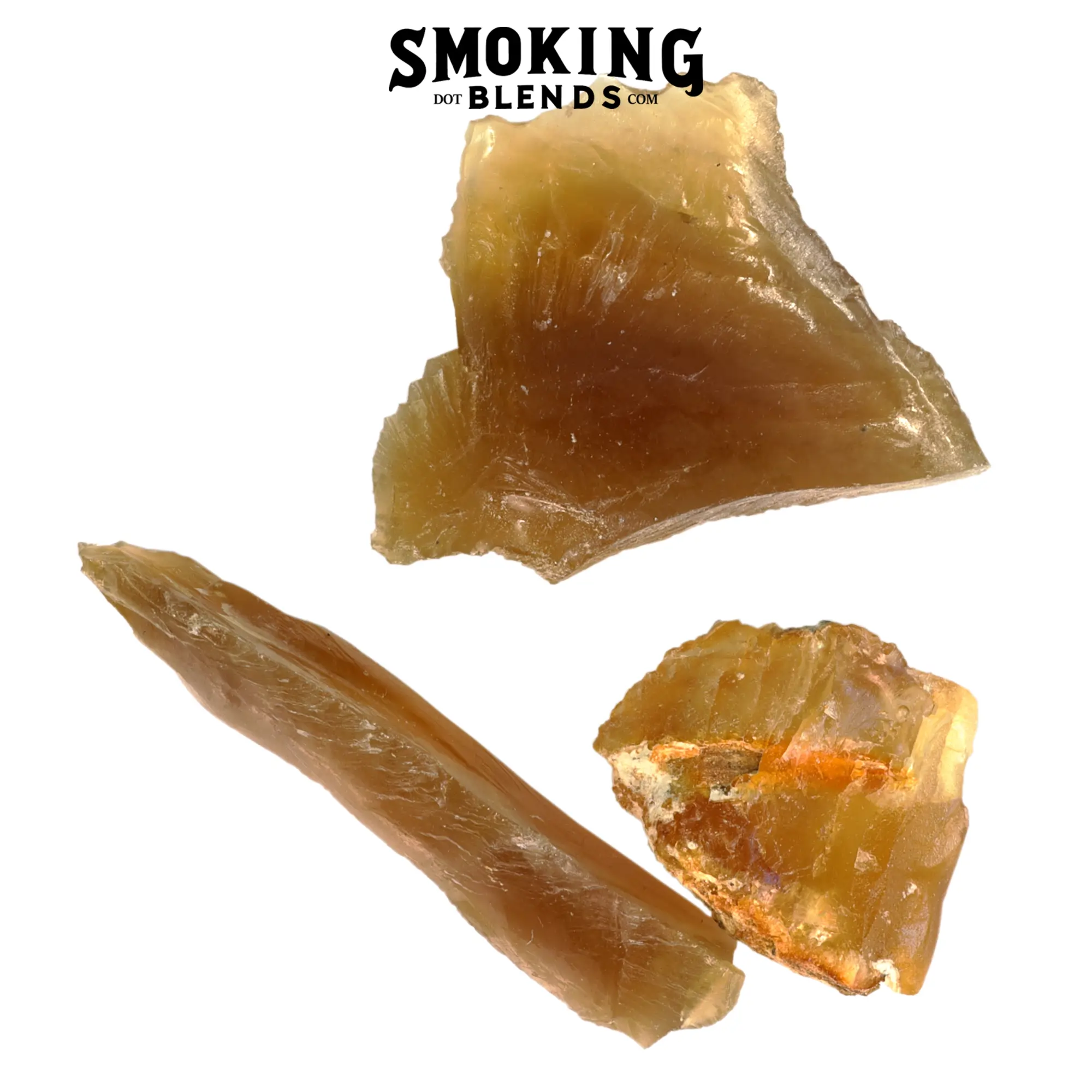 Three pieces of translucent golden and brown amber resin incense, including a wedge, a long shard, and a rough chunk, on a white background. Product image by SmokingBlends.com
