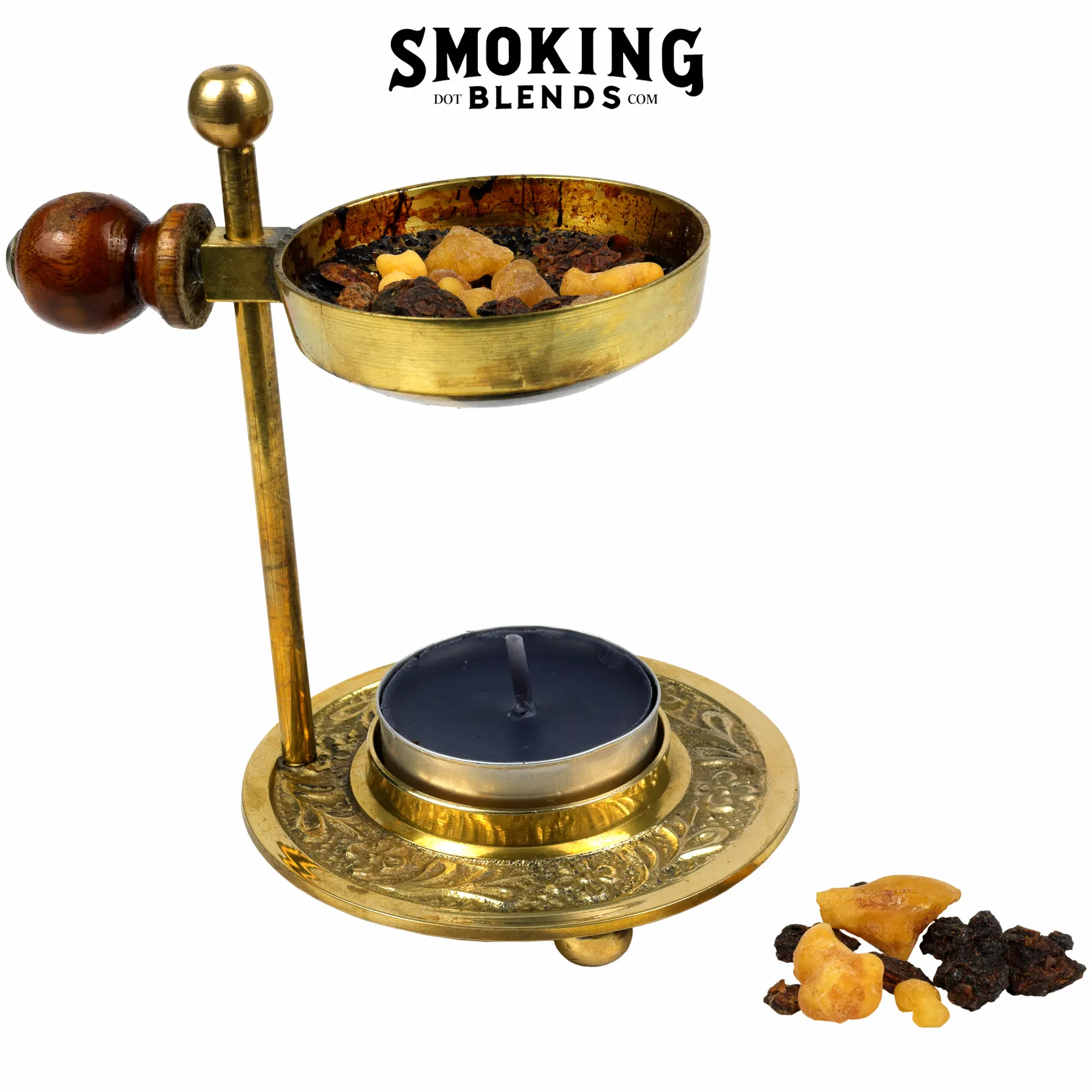 The image shows a brass tealight candle resin incense burner with a dark-colored tealight candle, some yellow frankincense, and dark brown myrrh resin pieces sitting on the plate and next to the burner.
